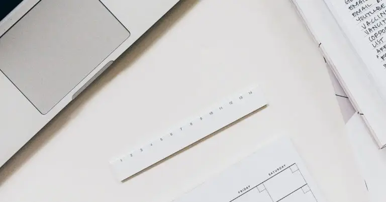 close up of paper and a laptop on a desk