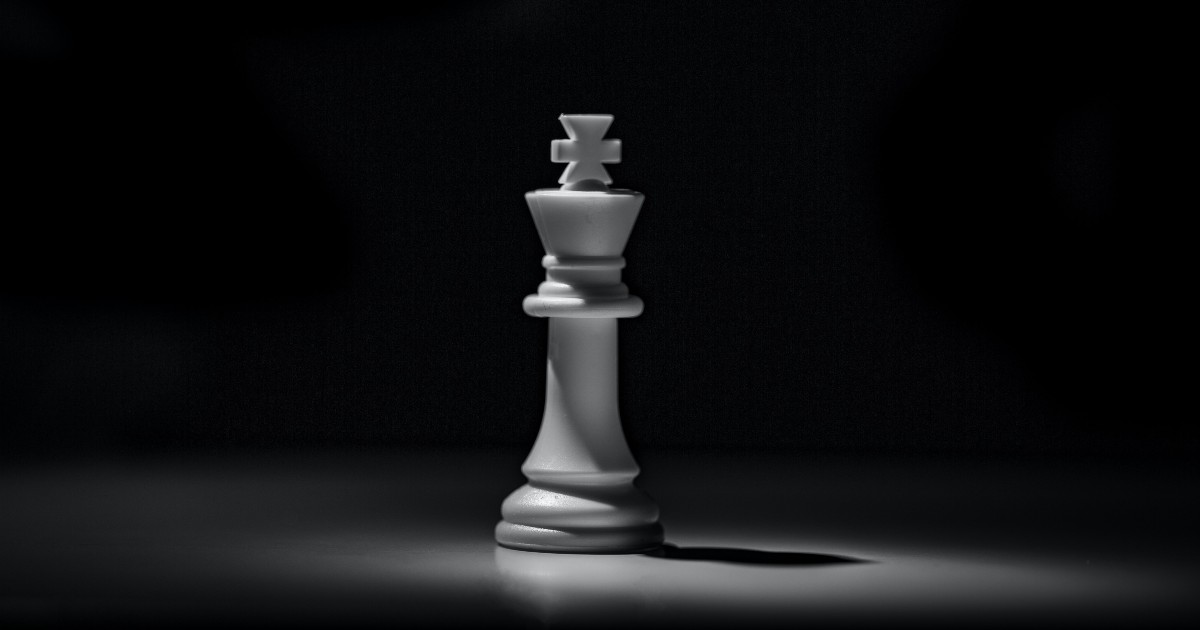picture of a chess piece on a board with a black background